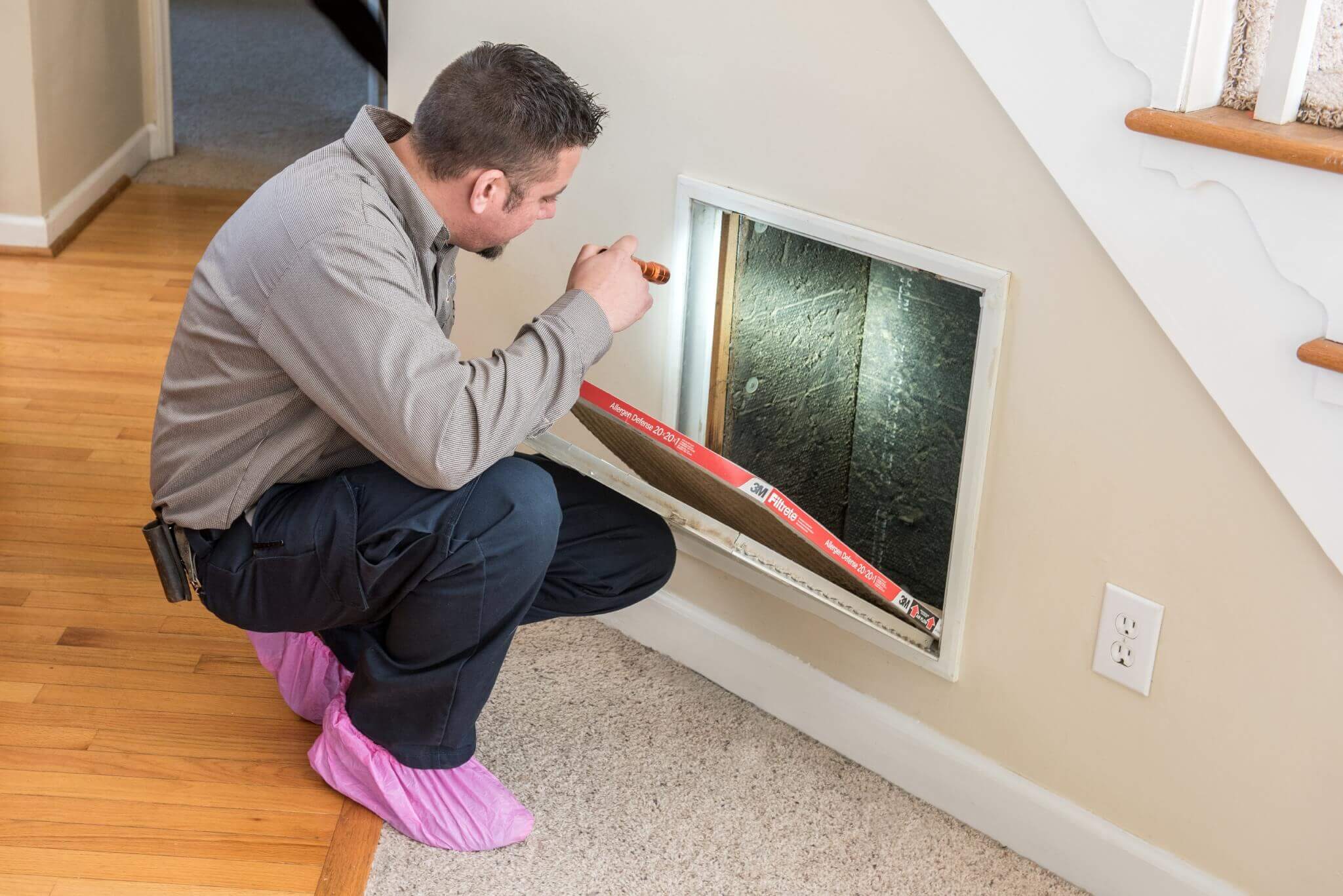 Technician Inspecting Air Duct