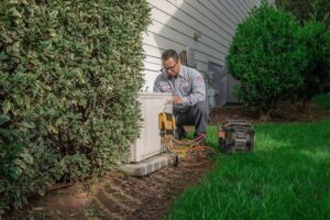 HVAC technican inspecting a home's outdoor AC unit.