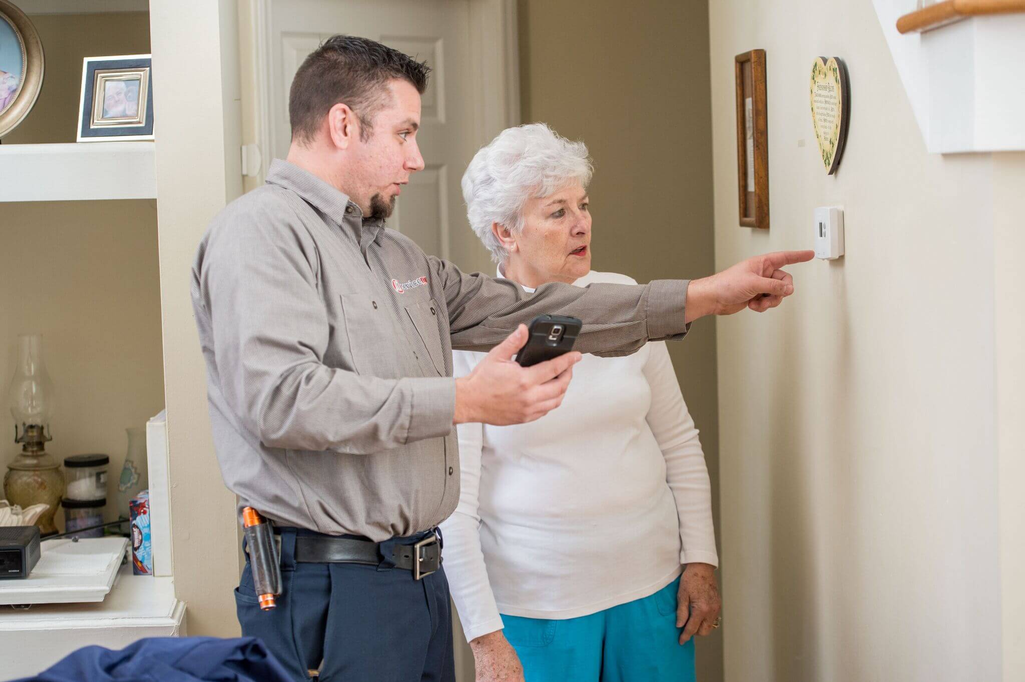 HVAC technician helping customer