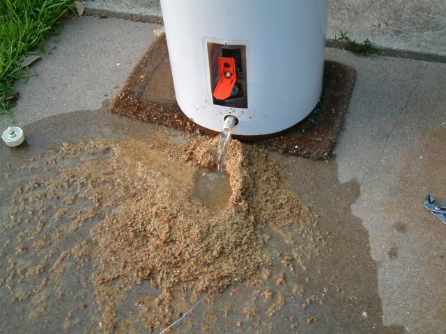 Draining water heater with surrounding sediment