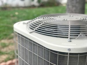 Up-close shot of an AC unit outside of a house.