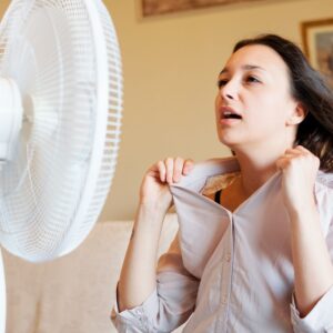 woman sitting in front of a fan