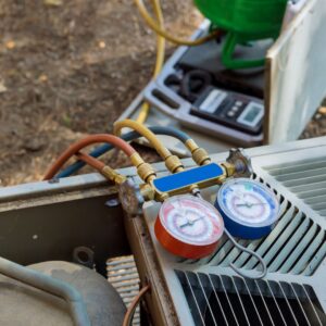 air conditioning gauges sitting on top of an air conditioner unit