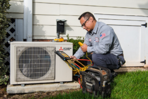 JD Service Now AC technician inspecting a heat pump