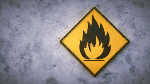flammable warning yellow sign on gray wall